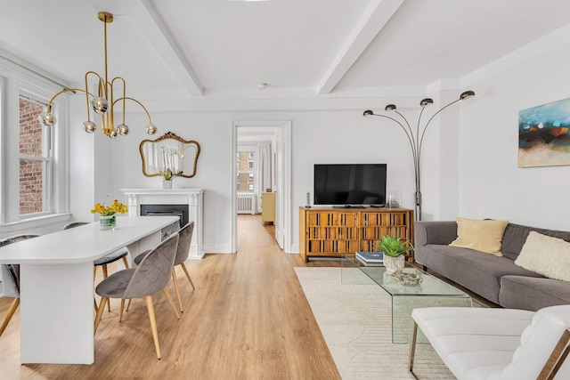400 E 59th St Unit 9G, New York City, NY 10022 - living room featuring beam ceiling, light wood-type flooring, a fireplace, a chandelier, and baseboards