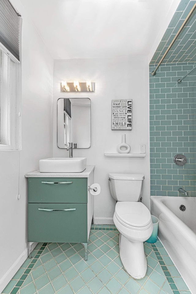 full bath featuring tile patterned flooring, baseboards, vanity, toilet, and  shower combination