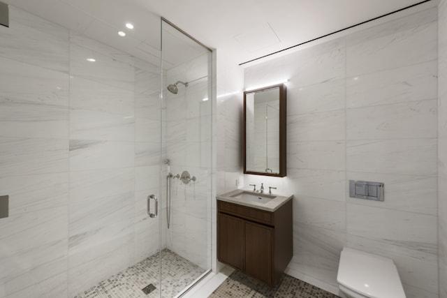 full bath with tile walls, a stall shower, vanity, toilet, and recessed lighting
