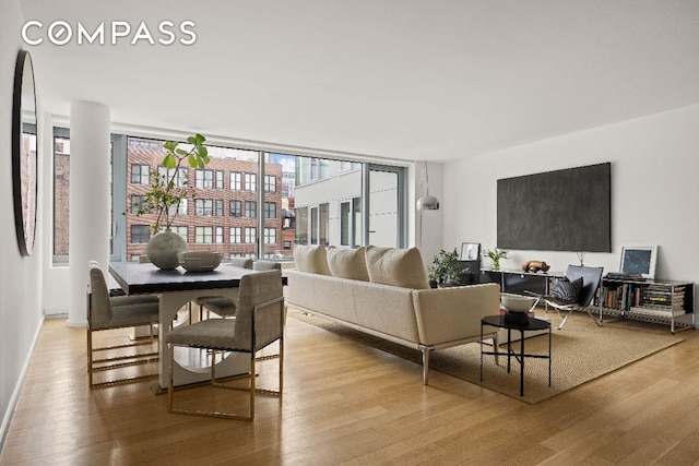 living room featuring light wood-style flooring and baseboards