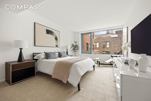 bedroom with light colored carpet