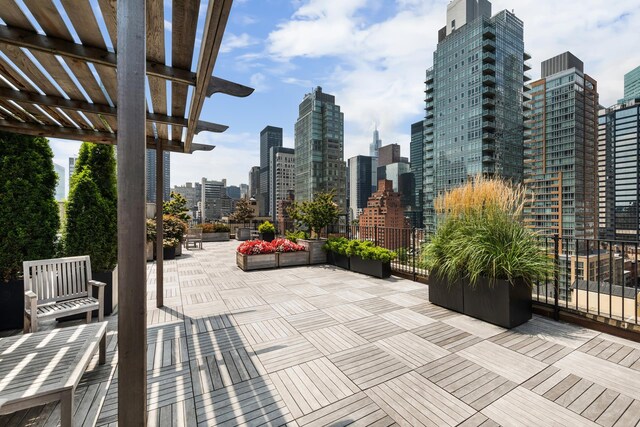 view of patio with a pergola and a city view