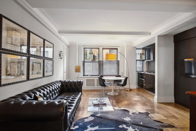 living area with beamed ceiling, baseboards, and ornamental molding