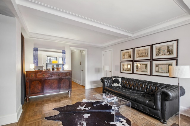 living area with baseboards and crown molding