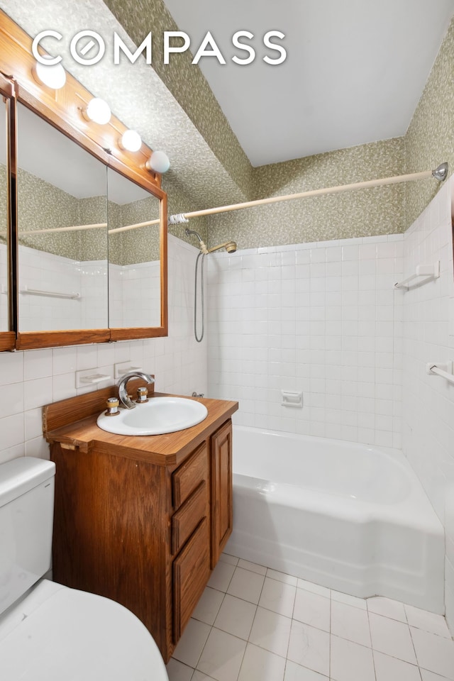311 E 71st St Unit 8G, New York City, NY 10021 - bathroom featuring tile patterned flooring, vanity, shower / bathtub combination, and tile walls