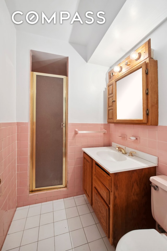 311 E 71st St Unit 8G, New York City, NY 10021 - full bath with tile walls, vanity, a stall shower, and wainscoting