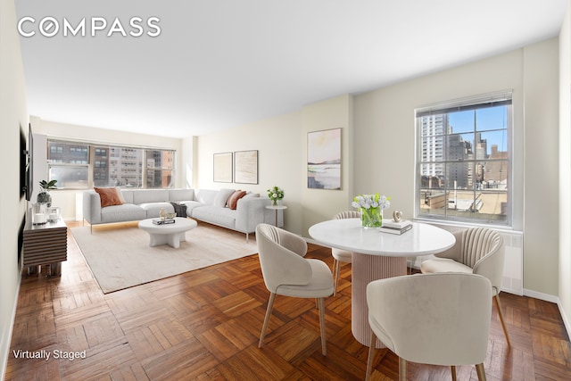 dining area with baseboards and a city view