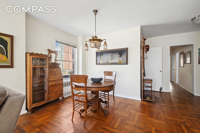 311 E 71st St Unit 8G, New York City, NY 10021 - dining area featuring radiator heating unit and a chandelier