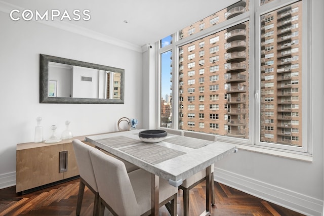 dining space with visible vents, crown molding, and baseboards