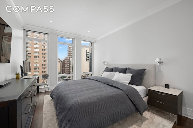 bedroom with recessed lighting, crown molding, baseboards, and wood finished floors