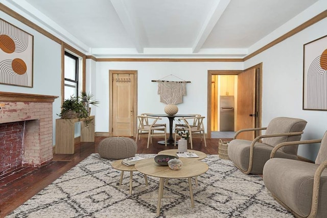 living area with beamed ceiling, baseboards, wood finished floors, and a fireplace