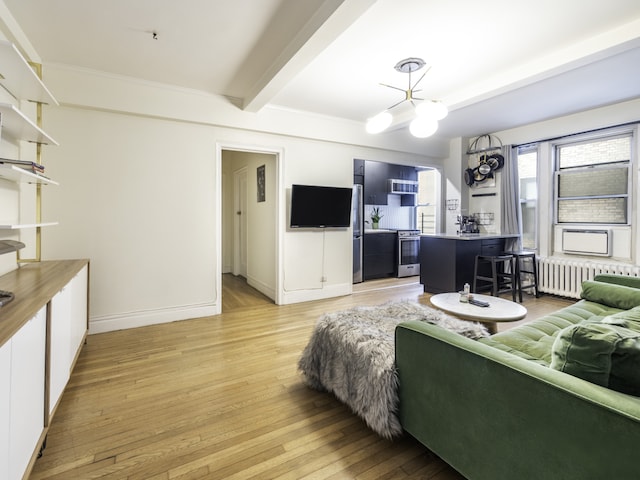 living room with baseboards, radiator heating unit, light wood-style flooring, a chandelier, and beam ceiling