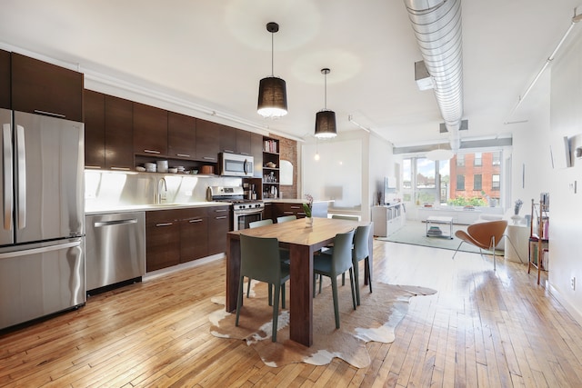 dining area featuring light wood finished floors