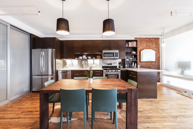 kitchen with open shelves, stainless steel appliances, light countertops, dark brown cabinetry, and decorative light fixtures