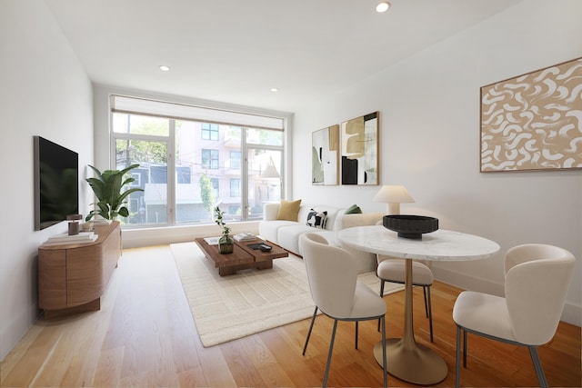 dining room with light wood-style flooring and recessed lighting