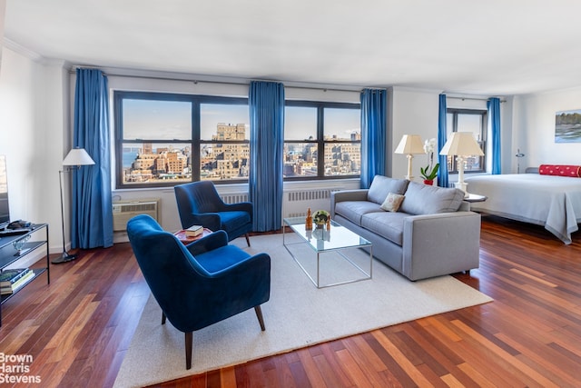 living area featuring dark wood-type flooring, an AC wall unit, a city view, and ornamental molding