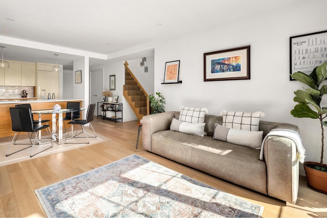 living area featuring light wood-style floors and stairs