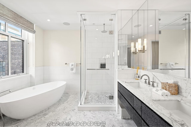 215 Sullivan St Unit 4A, New York City, NY 10012 - full bath with a shower stall, a freestanding tub, double vanity, marble finish flooring, and tile walls