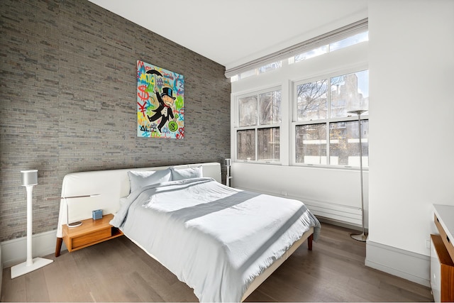 215 Sullivan St Unit 4A, New York City, NY 10012 - bedroom featuring a towering ceiling, wood finished floors, and baseboards