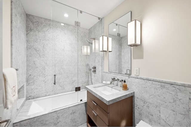 215 Sullivan St Unit 4A, New York City, NY 10012 - bathroom with vanity, bath / shower combo with glass door, and tile walls