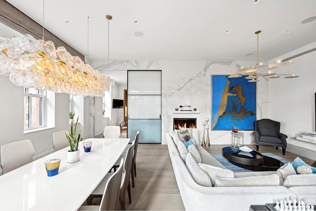 215 Sullivan St Unit 4A, New York City, NY 10012 - dining room with wood finished floors, a fireplace, and a chandelier
