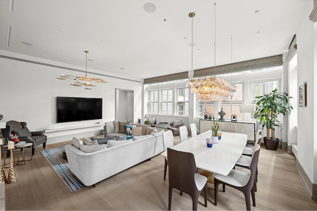 215 Sullivan St Unit 4A, New York City, NY 10012 - dining area featuring a chandelier and wood finished floors