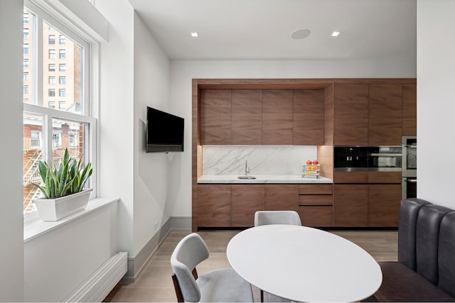 215 Sullivan St Unit 4A, New York City, NY 10012 - dining space with light wood-style flooring and baseboards