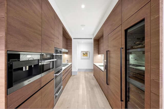 215 Sullivan St Unit 4A, New York City, NY 10012 - kitchen with modern cabinets, stainless steel appliances, light wood-type flooring, and light countertops