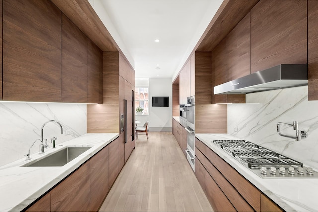 215 Sullivan St Unit 4A, New York City, NY 10012 - kitchen with modern cabinets, a sink, appliances with stainless steel finishes, backsplash, and recessed lighting