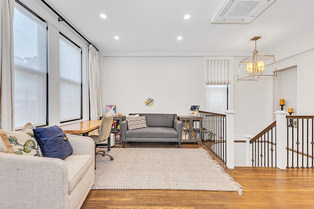 24 W 69th St Unit 9B, New York City, NY 10023 - living area featuring recessed lighting, a notable chandelier, wood finished floors, and visible vents