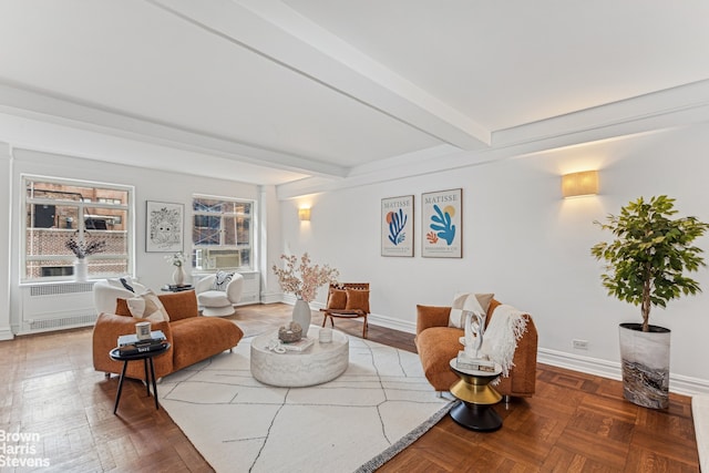 living area with baseboards and beamed ceiling