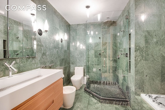 full bath with toilet, a stall shower, a bidet, and tile walls