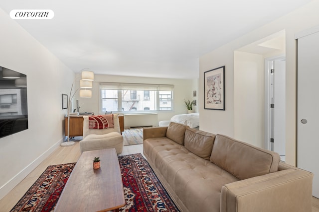 living area with light wood-type flooring, visible vents, and baseboards