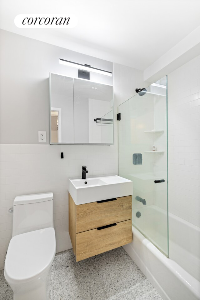 333 E 66th St Unit 5R, New York City, NY 10065 - full bath featuring speckled floor, bathtub / shower combination, vanity, and tile walls