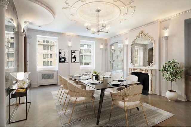 dining room with ornamental molding, parquet flooring, an inviting chandelier, and a raised ceiling