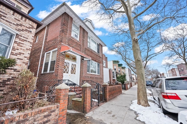 1741 73rd St, New York City, NY 11204 - view of home's exterior featuring brick siding and a fenced front yard