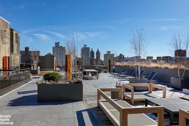 view of patio / terrace featuring a view of city and outdoor dining area