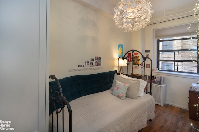 bedroom featuring dark wood-style flooring, baseboards, and an inviting chandelier