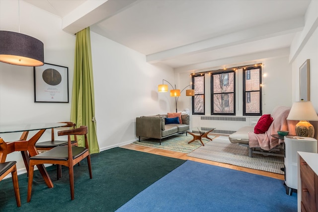 70 Park Ter W Unit E-23, New York City, NY 10034 - living area with radiator, wood finished floors, beam ceiling, and baseboards