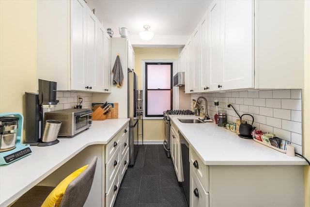 70 Park Ter W Unit E-23, New York City, NY 10034 - kitchen with stainless steel appliances, white cabinets, baseboards, backsplash, and light countertops