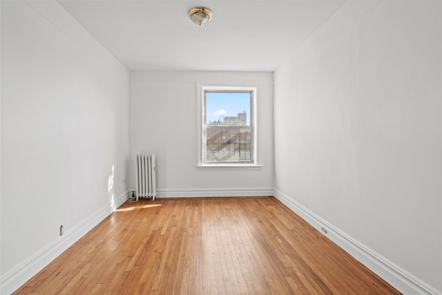 45-08 40th St Unit A42, New York City, NY 11104 - unfurnished room featuring radiator, light wood-type flooring, and baseboards