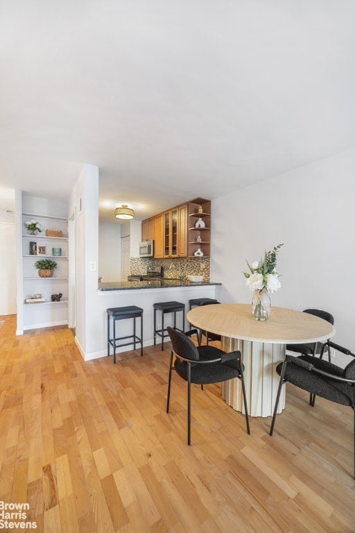 dining space with light wood-style flooring