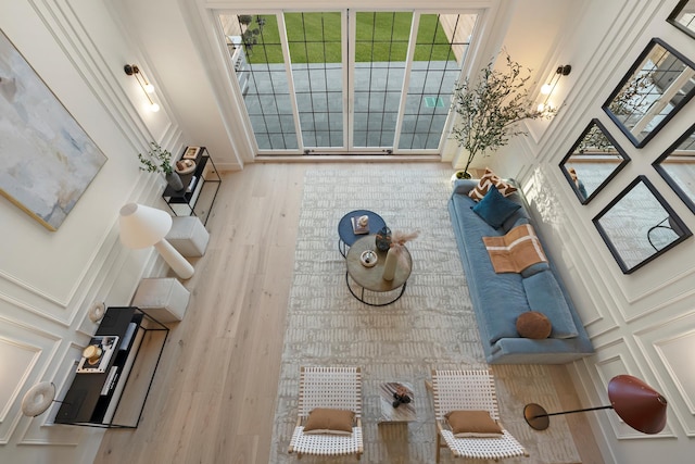 living room with wood finished floors and a decorative wall