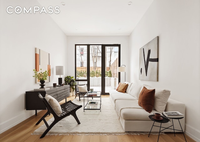 living area with wood finished floors and baseboards