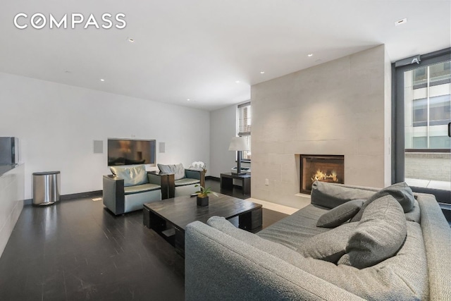 living room featuring a wealth of natural light, hardwood / wood-style flooring, and a fireplace