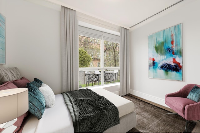 bedroom with baseboards and wood finished floors