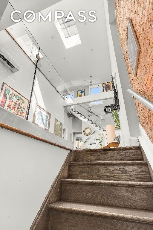 stairway featuring a skylight