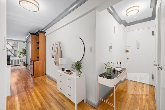 345 E 54th St Unit 3C, New York City, NY 10022 - hallway featuring radiator heating unit, light wood-style floors, and ornamental molding
