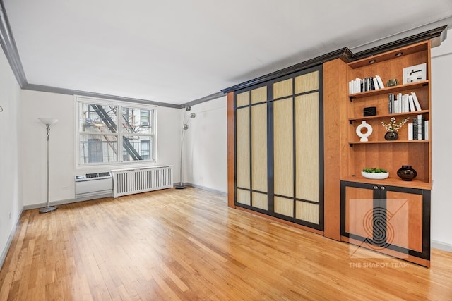 345 E 54th St Unit 3C, New York City, NY 10022 - empty room featuring ornamental molding, wood finished floors, radiator heating unit, and baseboards