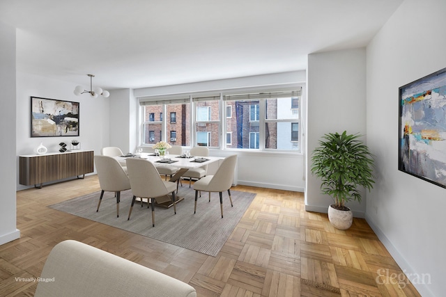 dining space featuring a notable chandelier, radiator, and baseboards